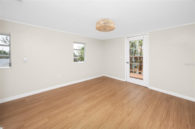 13148 3rd St E, Madeira Beach, FL 33708 - unfurnished room with baseboards, light wood finished floors, and plenty of natural light