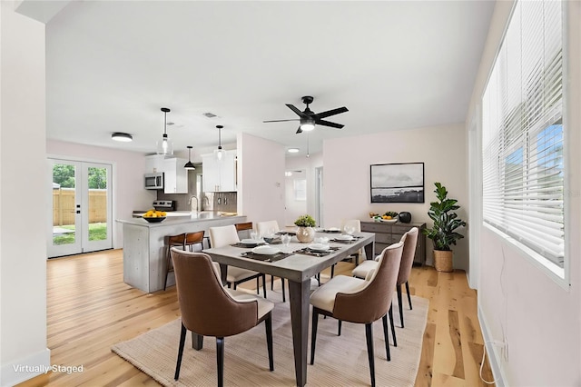 4414 W Oklahoma Ave, Tampa, FL 33616 - dining area featuring light wood-style flooring, ceiling fan, and french doors