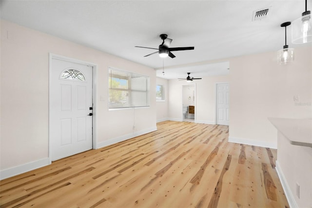 4414 W Oklahoma Ave, Tampa, FL 33616 - unfurnished living room featuring a ceiling fan and light wood-style floors