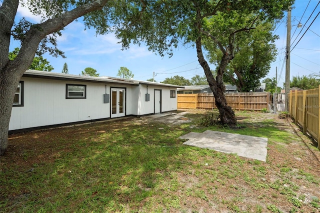 4414 W Oklahoma Ave, Tampa, FL 33616 - back of house featuring french doors, a fenced backyard, and a patio