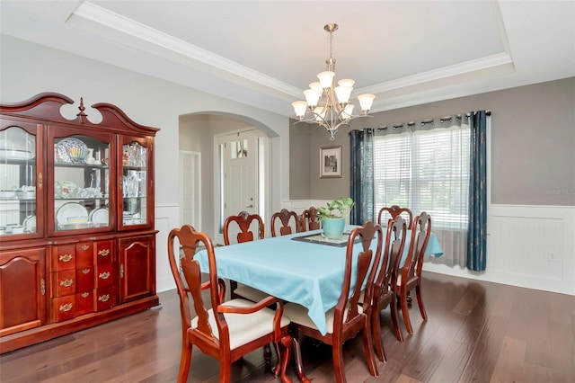 26972 Evergreen Chase Dr, Wesley Chapel, FL 33544 - dining room with a raised ceiling, arched walkways, dark wood-style floors, a chandelier, and wainscoting