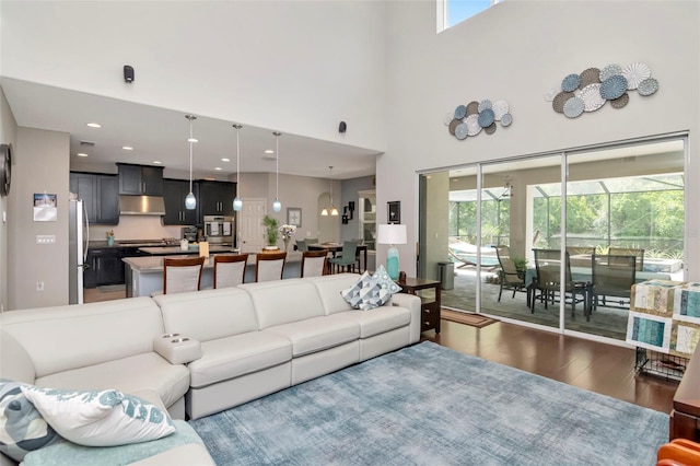 26972 Evergreen Chase Dr, Wesley Chapel, FL 33544 - living area with wood finished floors, a towering ceiling, and recessed lighting
