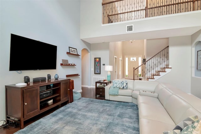 26972 Evergreen Chase Dr, Wesley Chapel, FL 33544 - living area featuring arched walkways, a high ceiling, stairway, and wood finished floors