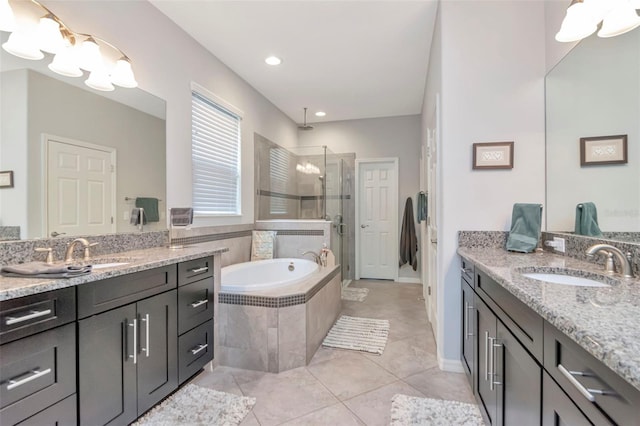 26972 Evergreen Chase Dr, Wesley Chapel, FL 33544 - full bathroom with a shower stall, two vanities, a bath, tile patterned flooring, and recessed lighting