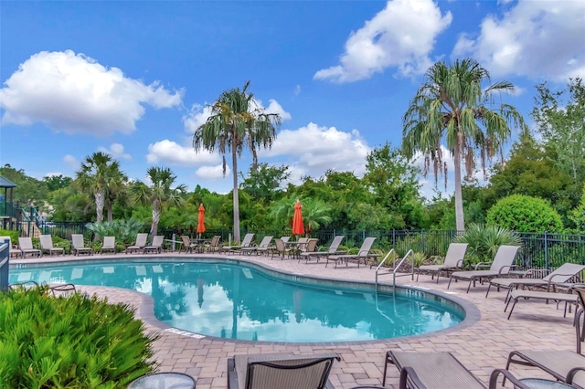 26972 Evergreen Chase Dr, Wesley Chapel, FL 33544 - community pool featuring a patio and view of scattered trees
