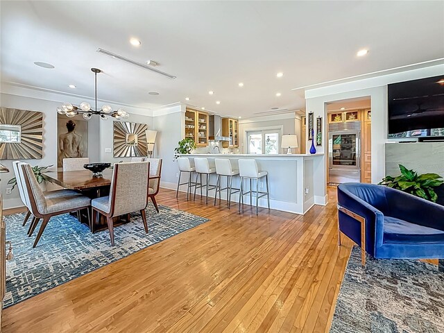 301 23rd Ave NE, Saint Petersburg, FL 33704 - dining area with ornamental molding, light wood finished floors, recessed lighting, and a chandelier