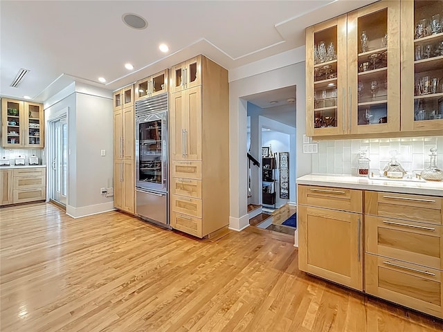 301 23rd Ave NE, Saint Petersburg, FL 33704 - kitchen featuring tasteful backsplash, light wood-style flooring, light countertops, glass insert cabinets, and recessed lighting
