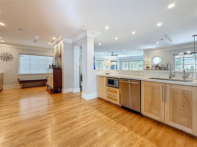 301 23rd Ave NE, Saint Petersburg, FL 33704 - kitchen with appliances with stainless steel finishes, light countertops, light wood-style flooring, recessed lighting, and ceiling fan