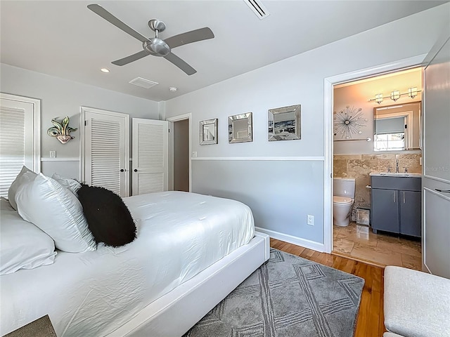 301 23rd Ave NE, Saint Petersburg, FL 33704 - bedroom featuring wood finished floors, ensuite bathroom, recessed lighting, a ceiling fan, and a closet