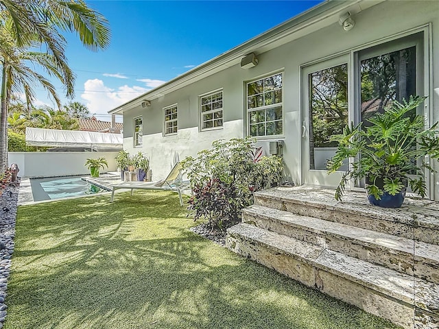 301 23rd Ave NE, Saint Petersburg, FL 33704 - rear view of house featuring stucco siding