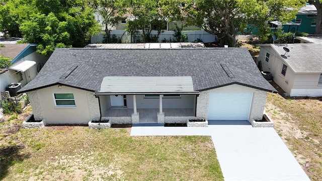 4638 Durney St, New Port Richey, FL 34652 - view of front of property featuring an attached garage, a porch, concrete driveway, a front yard, and a shingled roof