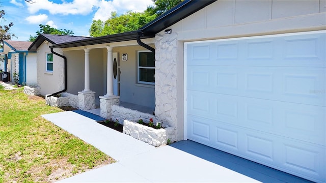4638 Durney St, New Port Richey, FL 34652 - view of front facade with stucco siding, an attached garage, covered porch, driveway, and stone siding