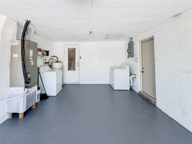 4638 Durney St, New Port Richey, FL 34652 - garage featuring washer and clothes dryer, concrete block wall, electric panel, and heating unit