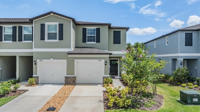36414 Well Hill Way, Zephyrhills, FL 33541 - multi unit property featuring an attached garage, driveway, stucco siding, stone siding, and a shingled roof