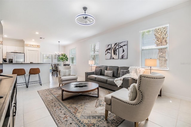 36414 Well Hill Way, Zephyrhills, FL 33541 - living room with crown molding, healthy amount of natural light, light tile patterned floors, recessed lighting, and a chandelier