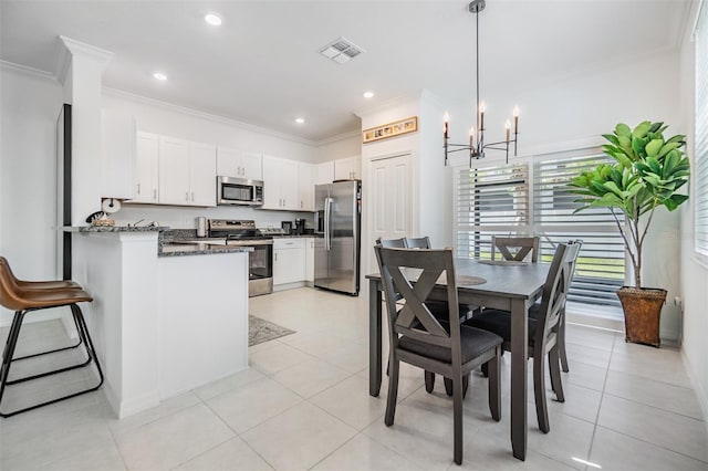 36414 Well Hill Way, Zephyrhills, FL 33541 - kitchen with stainless steel appliances, ornamental molding, white cabinetry, a peninsula, and a chandelier