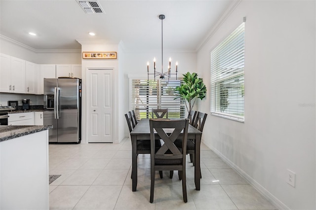 36414 Well Hill Way, Zephyrhills, FL 33541 - dining space with a chandelier, ornamental molding, and light tile patterned flooring