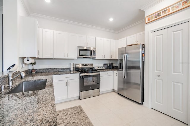 36414 Well Hill Way, Zephyrhills, FL 33541 - kitchen with stainless steel appliances, ornamental molding, dark stone counters, white cabinetry, and recessed lighting