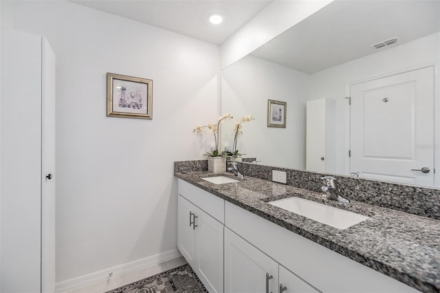 36414 Well Hill Way, Zephyrhills, FL 33541 - bathroom featuring double vanity and baseboards