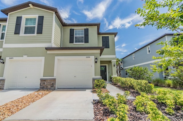 36414 Well Hill Way, Zephyrhills, FL 33541 - multi unit property featuring stucco siding, a garage, concrete driveway, and stone siding