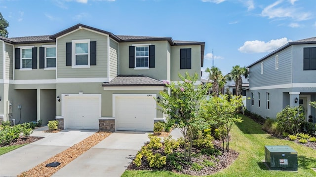 36414 Well Hill Way, Zephyrhills, FL 33541 - townhome / multi-family property with a garage, concrete driveway, stucco siding, stone siding, and roof with shingles