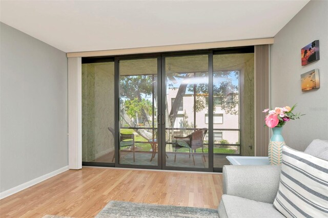 14130 Rosemary Ln Unit 3202, Largo, FL 33774 - doorway to outside with a wall of windows, french doors, plenty of natural light, and wood finished floors