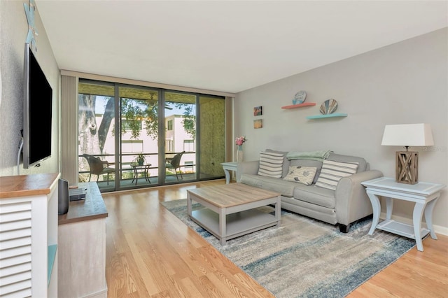 14130 Rosemary Ln Unit 3202, Largo, FL 33774 - living room with floor to ceiling windows and wood finished floors