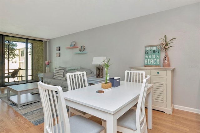 14130 Rosemary Ln Unit 3202, Largo, FL 33774 - dining room featuring light wood-style flooring and a wall of windows