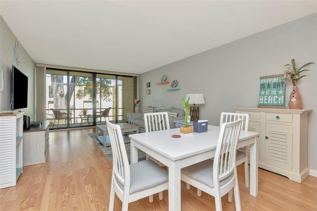 14130 Rosemary Ln Unit 3202, Largo, FL 33774 - dining space with expansive windows and light wood-style flooring