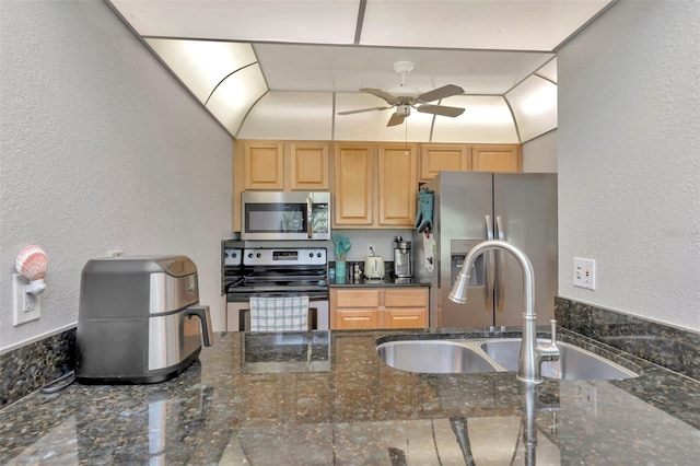 14130 Rosemary Ln Unit 3202, Largo, FL 33774 - kitchen with stainless steel appliances, ceiling fan, dark stone countertops, a textured wall, and light brown cabinetry
