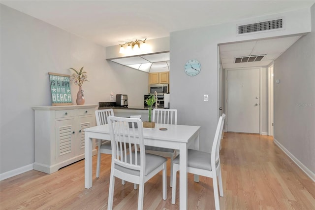 14130 Rosemary Ln Unit 3202, Largo, FL 33774 - dining area featuring light wood-style floors and baseboards