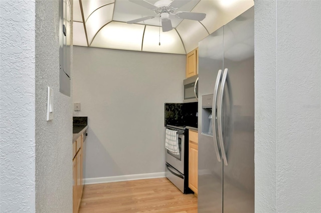 14130 Rosemary Ln Unit 3202, Largo, FL 33774 - kitchen featuring stainless steel appliances, light brown cabinetry, light wood-type flooring, dark countertops, and a ceiling fan