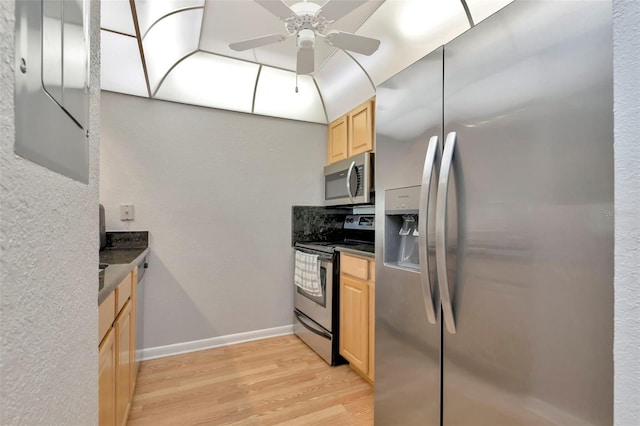 14130 Rosemary Ln Unit 3202, Largo, FL 33774 - kitchen featuring stainless steel appliances, light brown cabinetry, dark countertops, light wood-style floors, and a ceiling fan