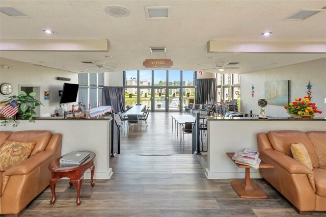 14130 Rosemary Ln Unit 3202, Largo, FL 33774 - living room with floor to ceiling windows, wood finished floors, and ceiling fan