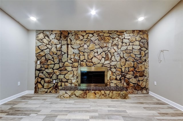 8330 Lafitte Dr, Hudson, FL 34667 - detailed view of wood finished floors, a glass covered fireplace, and baseboards