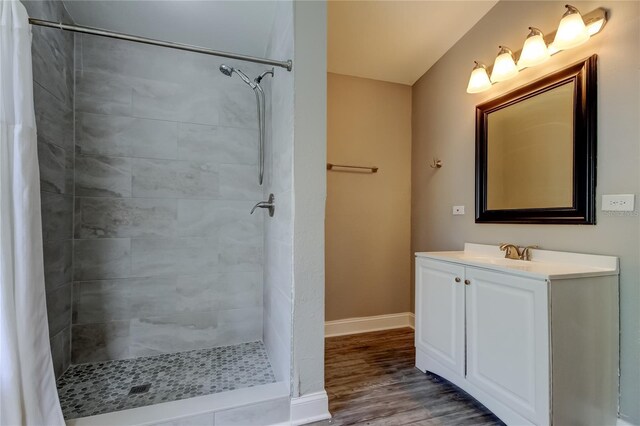 8330 Lafitte Dr, Hudson, FL 34667 - full bath featuring wood finished floors, tiled shower, vanity, and baseboards