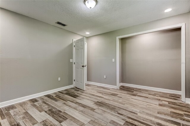 8330 Lafitte Dr, Hudson, FL 34667 - unfurnished room featuring wood finished floors, a textured ceiling, baseboards, and recessed lighting