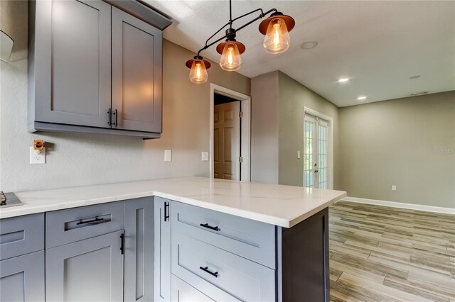 8330 Lafitte Dr, Hudson, FL 34667 - kitchen with gray cabinetry, a peninsula, light wood-style floors, and recessed lighting
