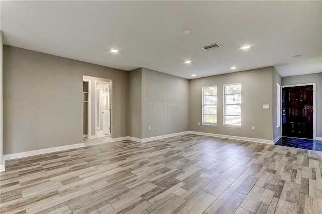8330 Lafitte Dr, Hudson, FL 34667 - empty room with light wood finished floors, baseboards, and recessed lighting