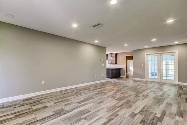 8330 Lafitte Dr, Hudson, FL 34667 - unfurnished living room with light wood finished floors, baseboards, and recessed lighting