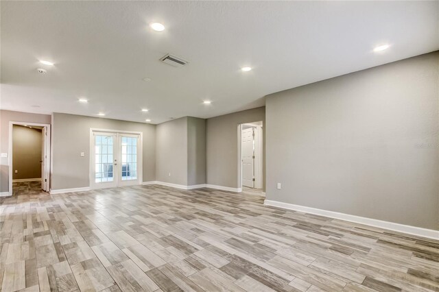8330 Lafitte Dr, Hudson, FL 34667 - empty room with baseboards, light wood finished floors, french doors, and recessed lighting