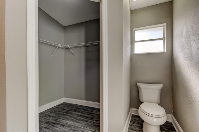 8330 Lafitte Dr, Hudson, FL 34667 - bathroom with toilet, wood finished floors, baseboards, and a walk in closet