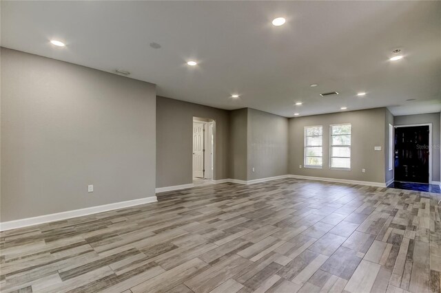 8330 Lafitte Dr, Hudson, FL 34667 - unfurnished room featuring baseboards, light wood finished floors, and recessed lighting