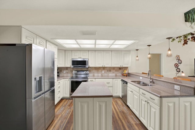 2806 Fairway View Dr, Valrico, FL 33596 - kitchen featuring appliances with stainless steel finishes, a peninsula, dark wood finished floors, and decorative backsplash