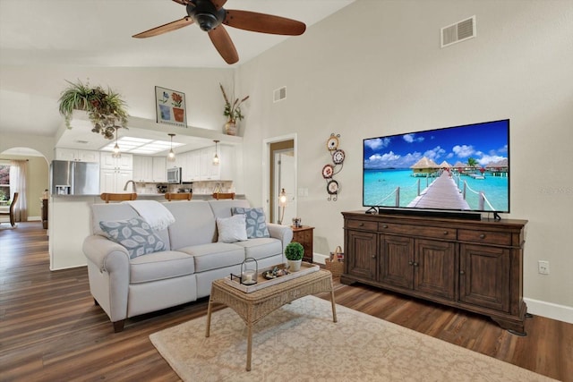 2806 Fairway View Dr, Valrico, FL 33596 - living room with dark wood finished floors, ceiling fan, arched walkways, and high vaulted ceiling