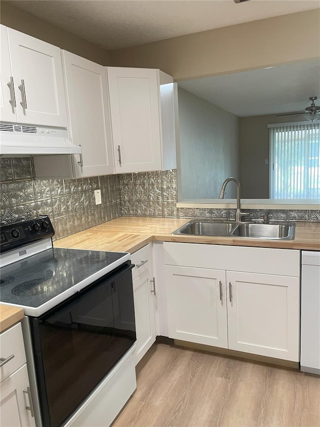 3007 Wainwright Ct, New Port Richey, FL 34655 - kitchen featuring range with electric stovetop, under cabinet range hood, butcher block counters, and a sink