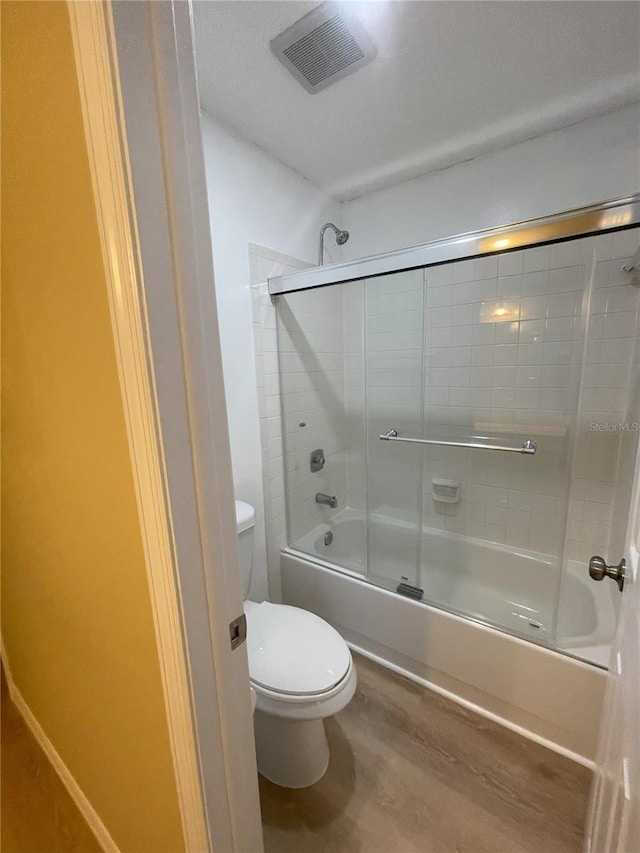 3007 Wainwright Ct, New Port Richey, FL 34655 - full bath with toilet, shower / bath combination with glass door, and wood finished floors