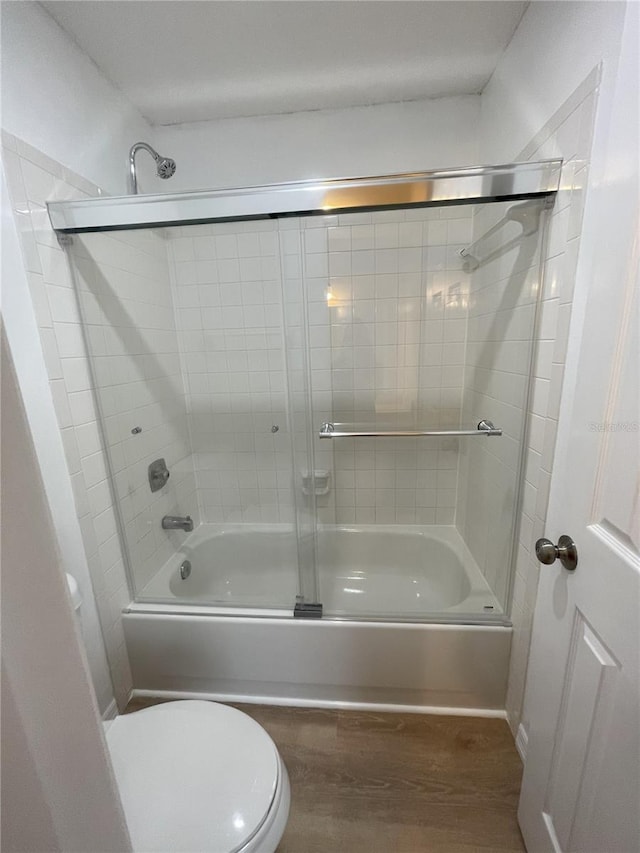3007 Wainwright Ct, New Port Richey, FL 34655 - full bath with toilet, wood finished floors, and combined bath / shower with glass door