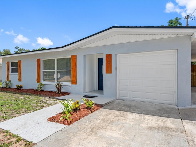 1213 W Camellia Dr, Brandon, FL 33510 - ranch-style house with an attached garage, stucco siding, and driveway