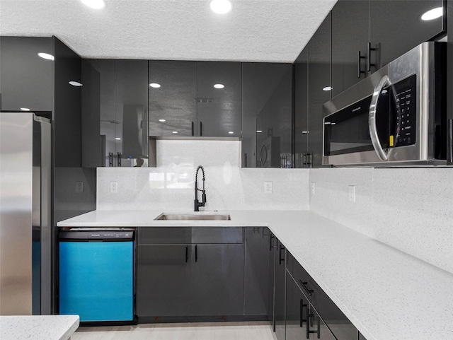 1213 W Camellia Dr, Brandon, FL 33510 - kitchen with appliances with stainless steel finishes, a sink, light countertops, modern cabinets, and backsplash
